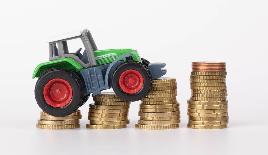 article hero image a toy tractor staged on coins. Very Cute!